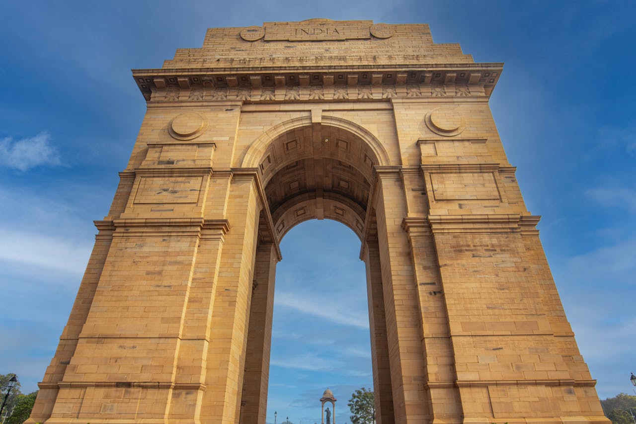 gallery-6 Stunning low-angle shot of the iconic India Gate monument in Delhi against a blue sky.