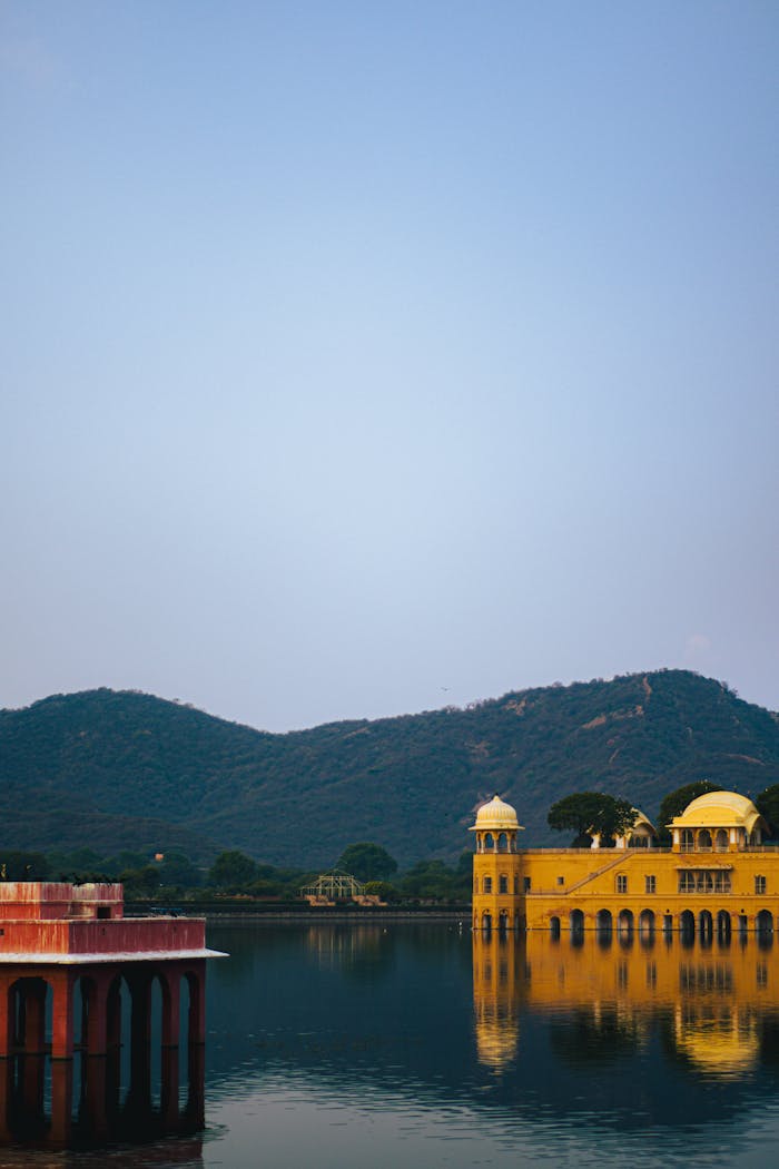 gallery-2 Stunning view of Jal Mahal in Jaipur at sunset with reflections on tranquil water.